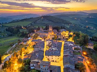 Tuscan vineyard and wine village from aerial point of view, Green vineyard during August before harvesting in Tuscany, The most beautiful vineyard in the world, The most sought-after wine destination, Chianti in Tuscany, Small wine town in Tuscany